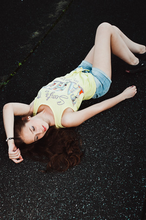 Girl having fun outdoor. Pretty girl sitting at school stadium. Rest from study. Outdoors, Lifestyleの写真素材