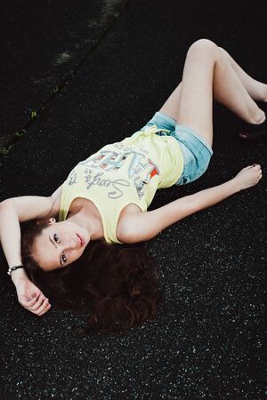 Girl having fun outdoor. Pretty girl sitting at school stadium. Rest from study. Outdoors, Lifestyleの写真素材