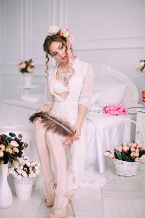 Beautiful young woman, hair decorated with flowers. Perfect makeup. Beauty fashion. Eyelashes. Studio retouched shot. Tender and sweet atmosphere, pastel colorsの写真素材