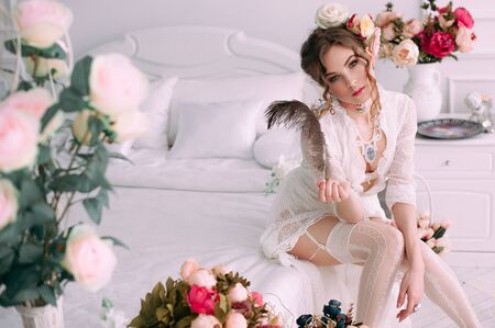 Beautiful young woman, hair decorated with flowers. Perfect makeup. Beauty fashion. Eyelashes. Studio retouched shot. Tender and sweet atmosphere, pastel colorsの写真素材