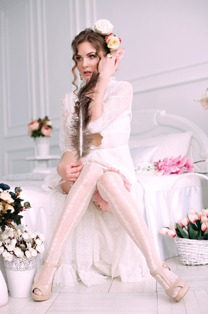 Beautiful young woman, hair decorated with flowers. Perfect makeup. Beauty fashion. Eyelashes. Studio retouched shot. Tender and sweet atmosphere, pastel colorsの写真素材