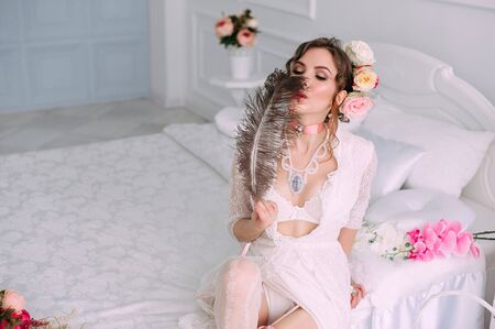 Beautiful young woman, hair decorated with flowers. Perfect makeup. Beauty fashion. Eyelashes. Studio retouched shot. Tender and sweet atmosphere, pastel colorsの写真素材
