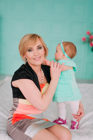 Portrait of a grandmother and her eight month old grandaughterの写真素材