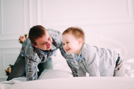 Young father and son playing together portrait. Studio shot.の写真素材