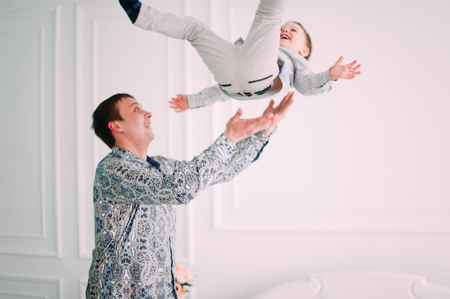 Young father and son playing together portrait. Studio shot.の写真素材