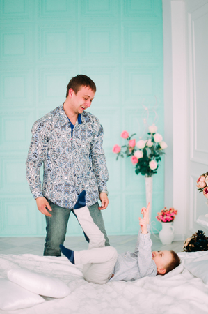 Young father and son playing together portrait. Studio shot.の写真素材