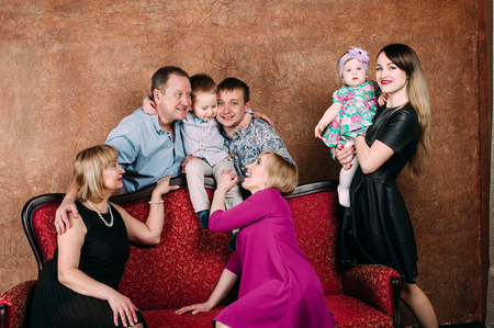 Three Generation Family Sitting On Sofa Together. Classic portraitの写真素材