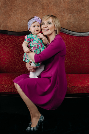 Portrait of a grandmother and her eight month old grandaughterの写真素材