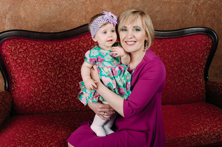 Portrait of a grandmother and her eight month old grandaughterの写真素材
