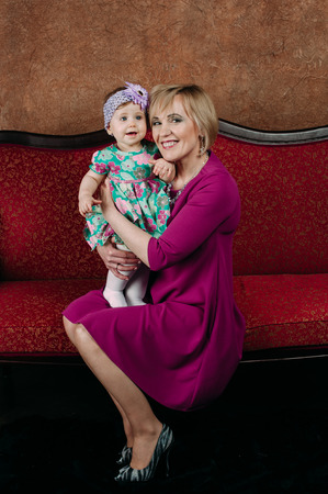 Portrait of a grandmother and her eight month old grandaughterの写真素材