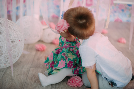 Smiling young brother and little cute todler sister in studioの写真素材