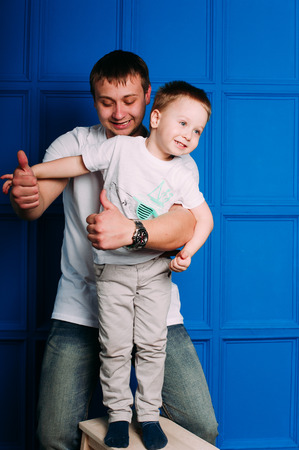 Young father and son playing together portrait. Studio shot.の写真素材