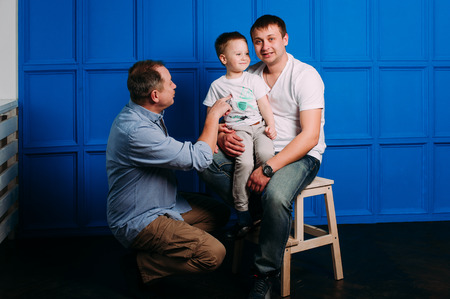Grandfather father and son smiling and having funの写真素材