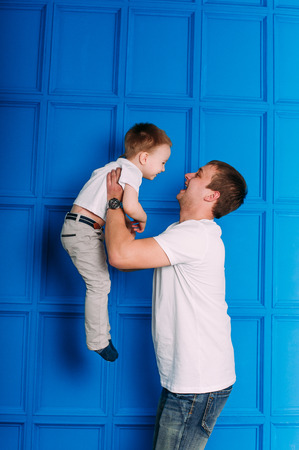 Young father and son playing together portrait. Studio shot.の写真素材