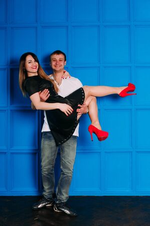 Portrait of young couple in love posing at studio dressed in classic clothesの写真素材