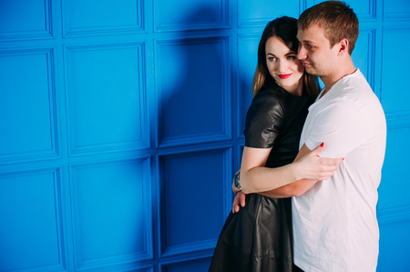 Portrait of young couple in love posing at studio dressed in classic clothesの写真素材