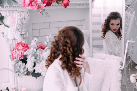 Beautiful young woman, hair decorated with flowers. Perfect makeup. Beauty fashion. Eyelashes. Studio retouched shot. Tender and sweet atmosphere, pastel colorsの写真素材