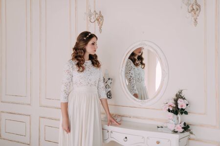 fashion studio photo of beautiful elegant bride with dark hair in luxurious wedding dressの写真素材