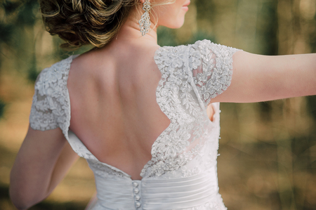 Back of beautiful bride with bridal bunchの写真素材