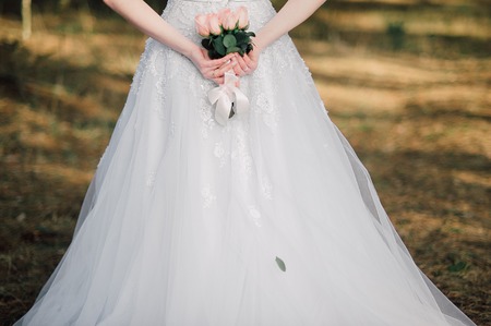Back of beautiful bride with bridal bunchの写真素材