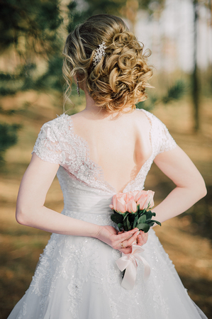 Back of beautiful bride with bridal bunchの写真素材