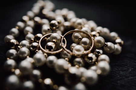 gold wedding rings on the pincushionの写真素材