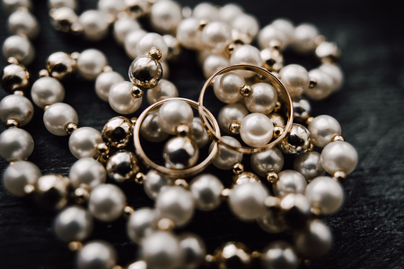 gold wedding rings on the pincushionの写真素材