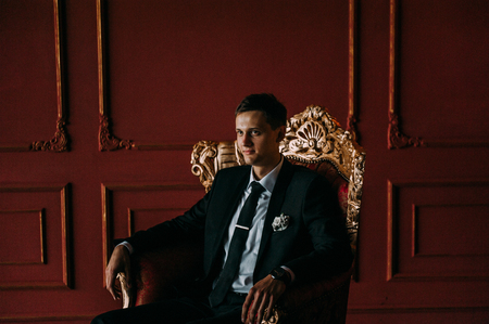 cute wedding couple in the interior of a classic studio decorated. hey kiss and hug each otherの写真素材