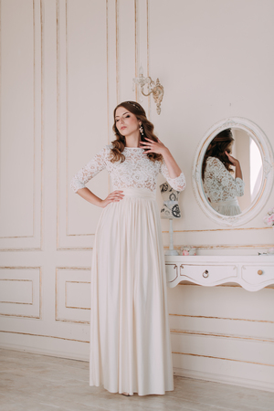 fashion studio photo of beautiful elegant bride with dark hair in luxurious wedding dressの写真素材