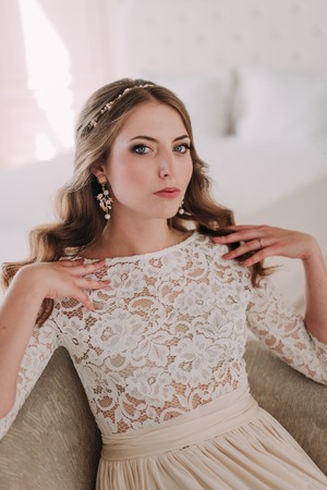 fashion studio photo of beautiful elegant bride with dark hair in luxurious wedding dressの写真素材