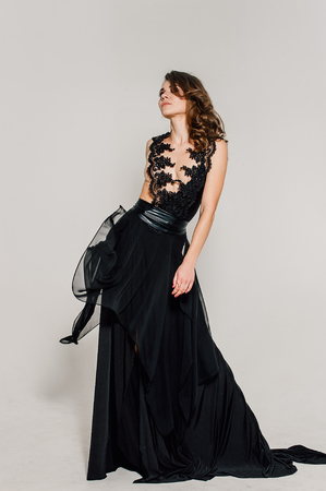 Individuality. Thoughtful Elegant Lady in Black Prom Evening Dress. Studio retouched photo.の写真素材