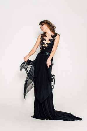 Individuality. Thoughtful Elegant Lady in Black Prom Evening Dress. Studio retouched photo.の写真素材