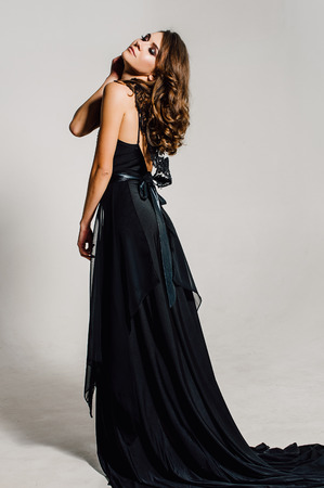 Individuality. Thoughtful Elegant Lady in Black Prom Evening Dress. Studio retouched photo.の写真素材
