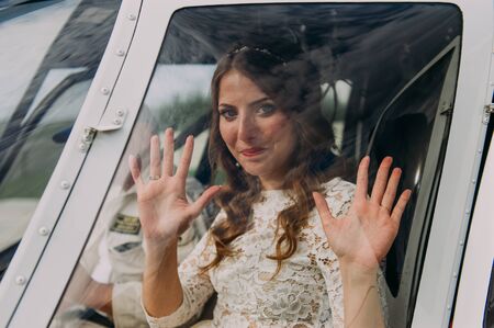 Happy beautiful newlyweds near the helicopterの写真素材