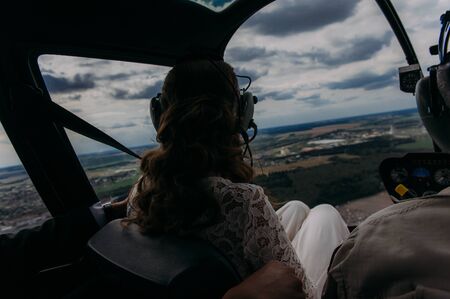 Happy beautiful newlyweds near the helicopterの写真素材