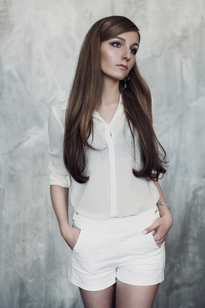 Fashion photo of young magnificent woman. Girl posing. Studio photo. beautiful girl studio white clothingの写真素材