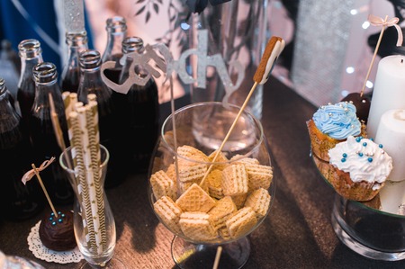 Candy bar on wedding ceremony with a lot of different candies and beveragesの写真素材