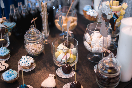 Candy bar on wedding ceremony with a lot of different candies and beveragesの写真素材
