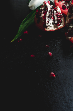 Delicious pomegranate fruit on black backgroundの写真素材