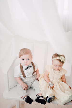 two babies - boy and girl dressed as bride and groomの写真素材