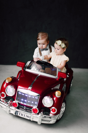 two babies - boy and girl dressed as bride and groomの写真素材