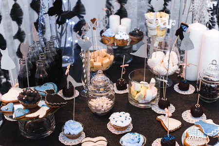 Candy bar on wedding ceremony with a lot of different candies and beveragesの写真素材