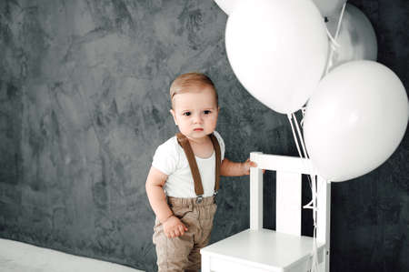 Portrait of lovely little boy happy smiling celebrating 1 year birthday. One year old european boy...