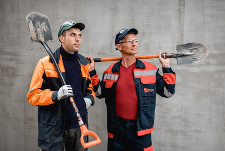 business, building, teamwork and people concept - group of smiling builders outdoorsの写真素材