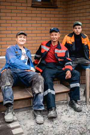 business, building, teamwork and people concept - group of smiling builders outdoorsの写真素材