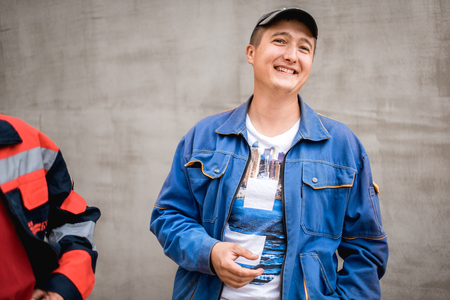 Young construction worker outdoors. Renovation background.