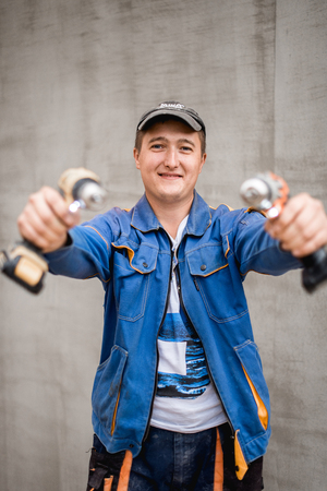 Young construction worker outdoors. Renovation background.の写真素材