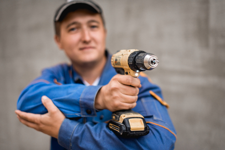 Young construction worker outdoors. Renovation background.の写真素材