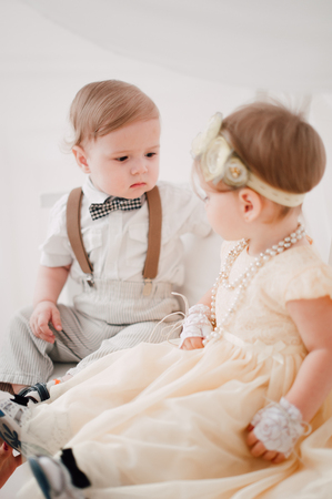 two babies - boy and girl dressed as bride and groomの写真素材