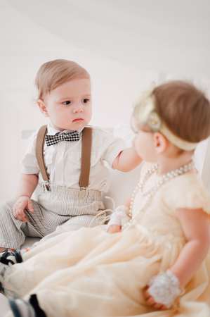 two babies - boy and girl dressed as bride and groomの写真素材